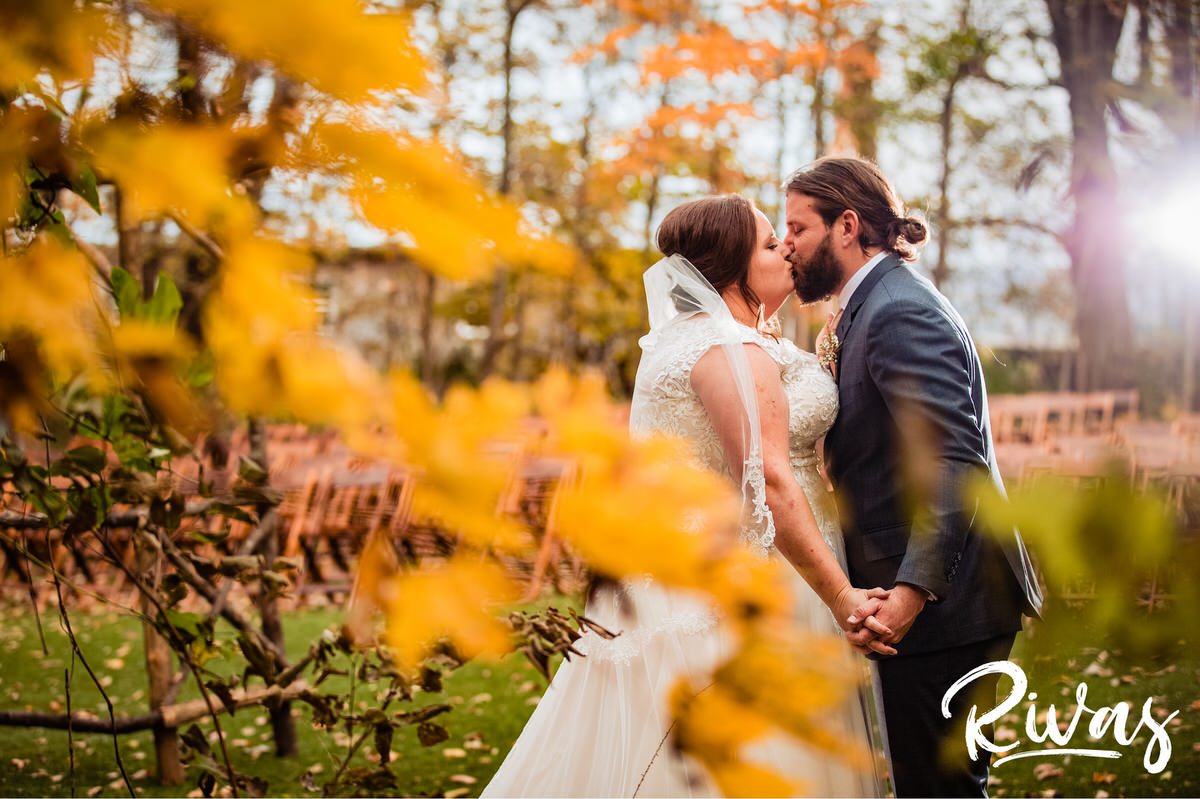 Schwinn Produce Farm Fall Wedding | Destination Wedding Photographers | A photo of a bride and groom sharing a kiss just after their first look on their wedding day.