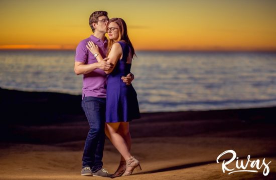 Sunset Cliffs Engagement Session Sneak Peek | Destination Engagement Photographers | An intimate picture of an engaged couple embracing while standing on the beach at San Diego's Sunset Cliffs during sunset on the evening of their engagement session.