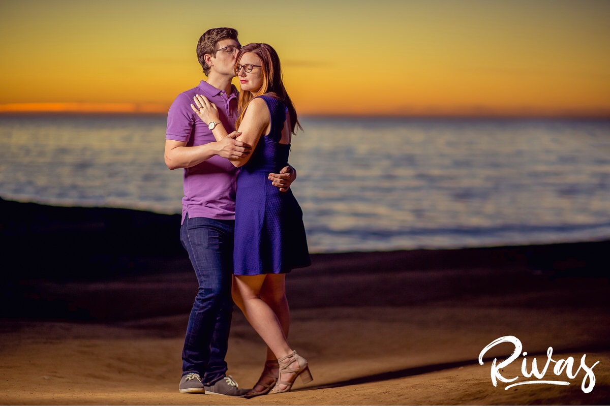 Sunset Cliffs Engagement Session Sneak Peek | Destination Engagement Photographers | An intimate picture of an engaged couple embracing while standing on the beach at San Diego's Sunset Cliffs during sunset on the evening of their engagement session.