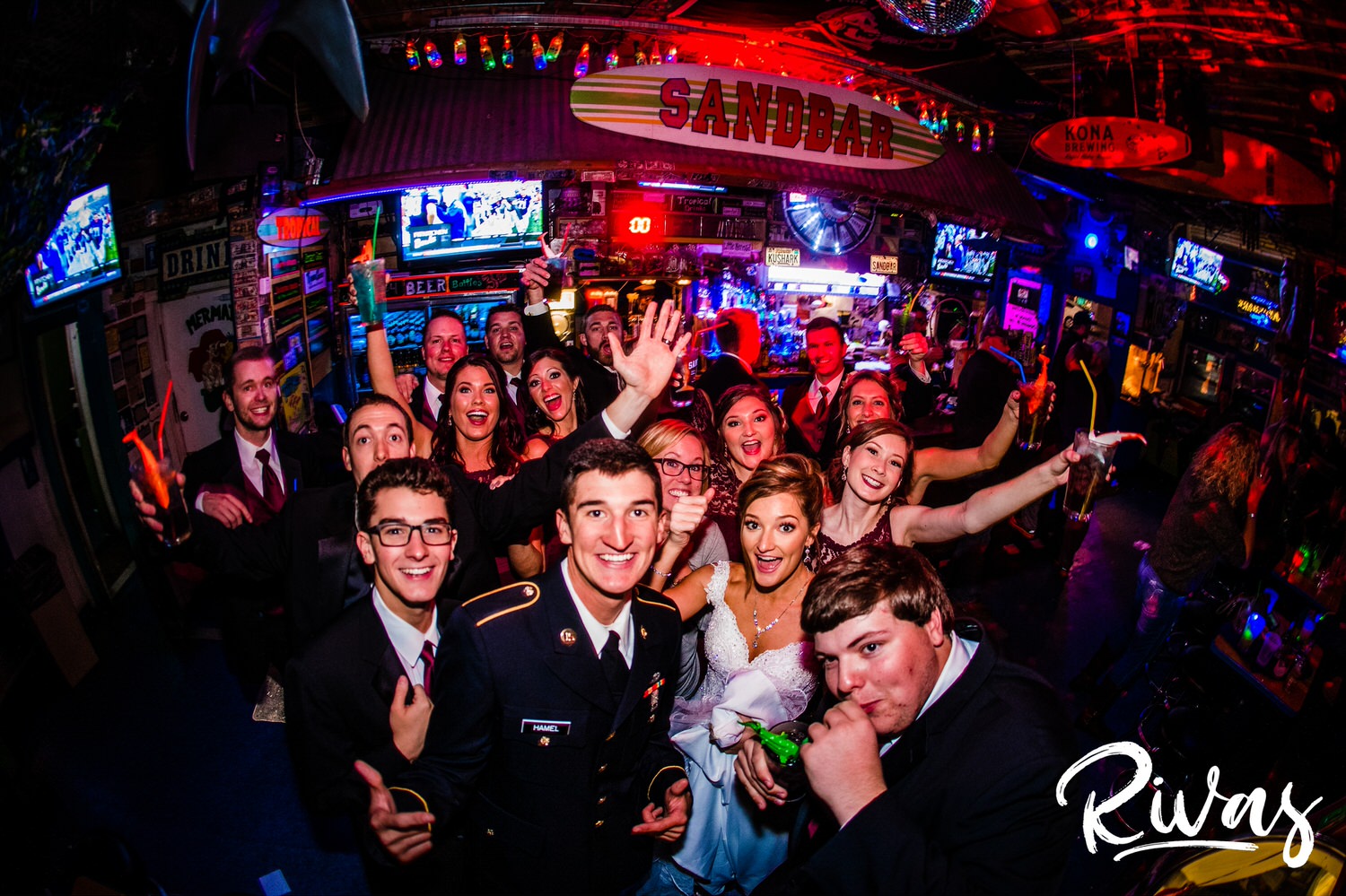 Tips For A Smooth Wedding Day | A young wedding party celebrating in a Lawrence Kansas bar