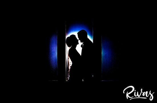5 Things to Think about when Hiring your Wedding Photographer | A dramatic silhouette portrait of a bride and groom spotlit in a white circle with blue background.