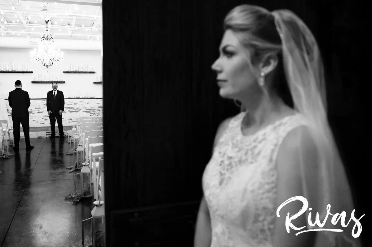 A candid picture of a bride walking into The Kingston Room at The Stanley in Lee's Summit to see her groom for the first time on the morning of their winter wedding. 