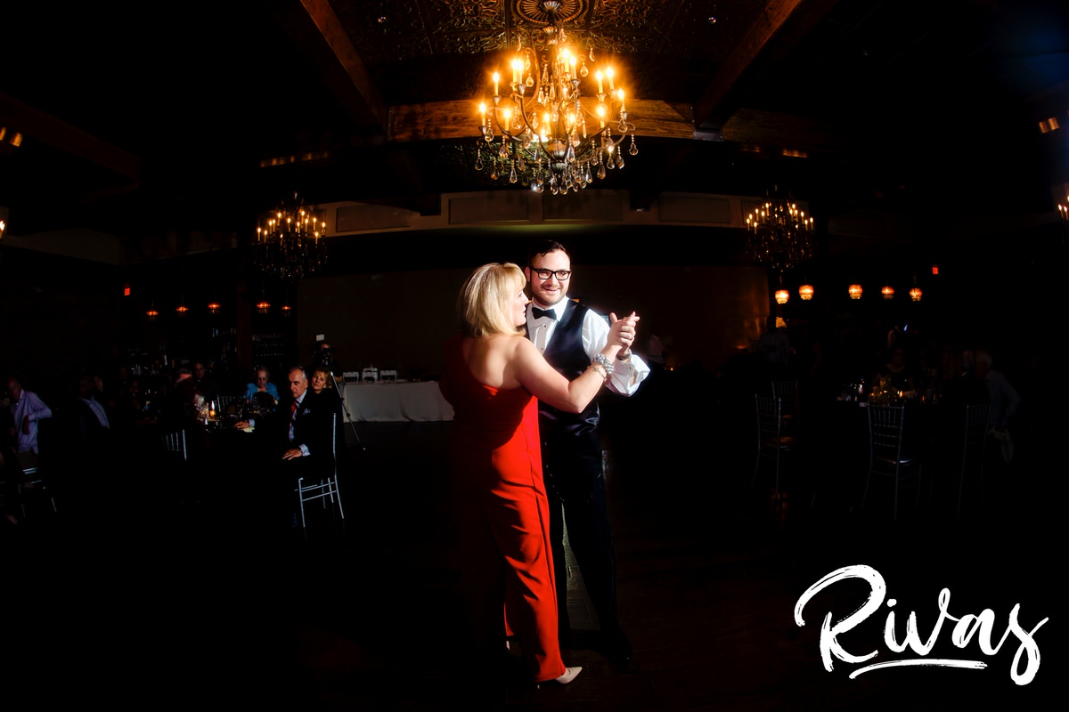 A wide picture of a groom dancing with his mom during the reception on the day of his winter wedding at The Stanley in downtown Lee's Summit. 