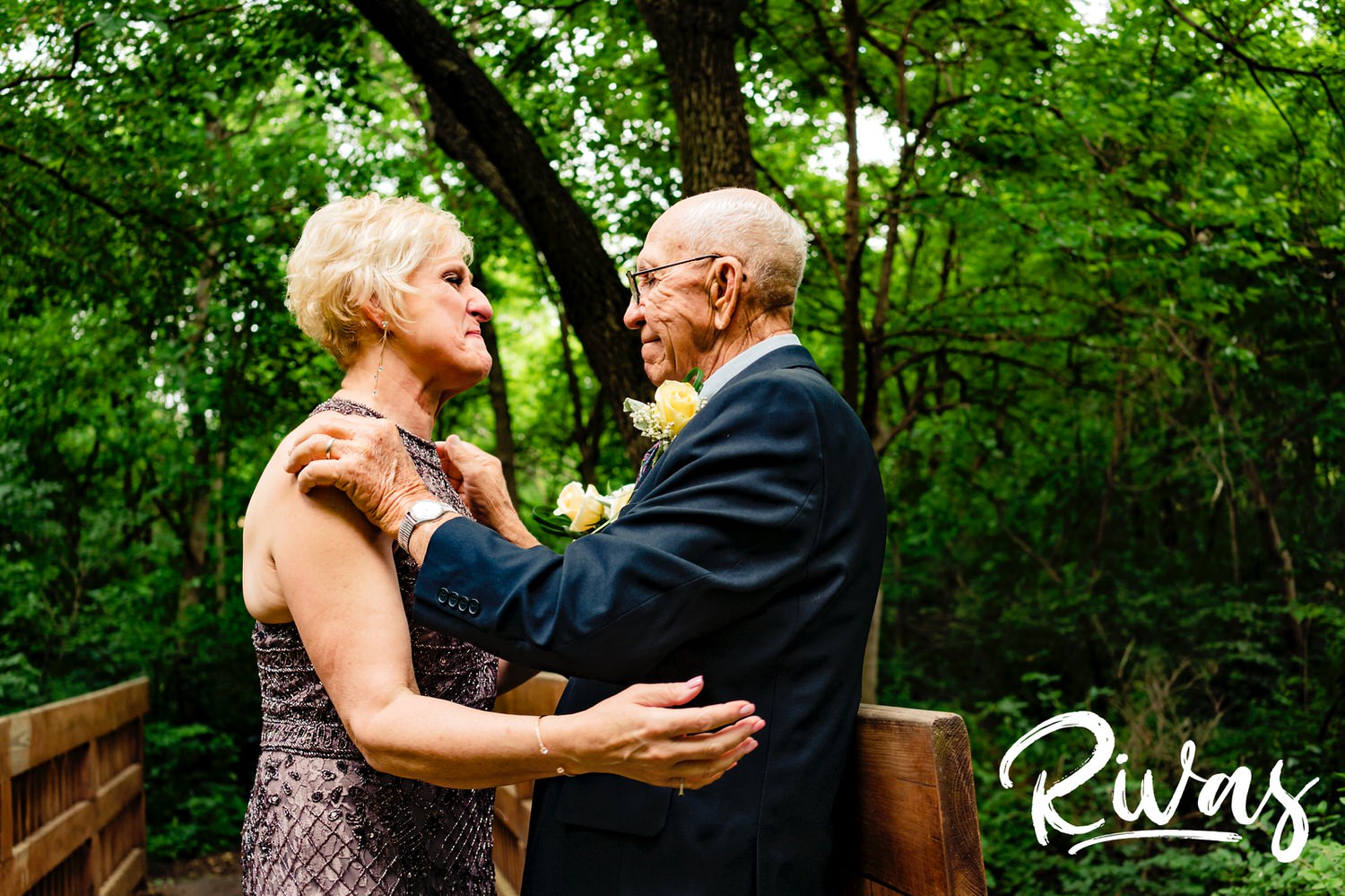 An emotional picture of a bride's father giving her a last hug and kiss before walking her down the aisle at her Omaha OPPD Arboretum Wedding. 