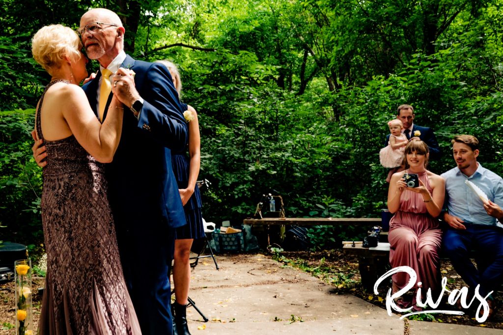 An intimate picture of a bride and groom dancing to music just after their wedding ceremony at the OPPD Arboretum in Omaha. 