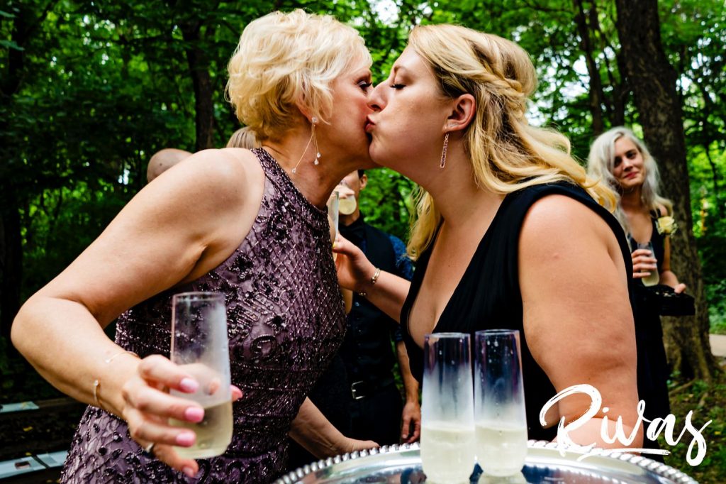 A sweet moment of a daughter kissing her mom on the cheek just after her mom's wedding ceremony. 