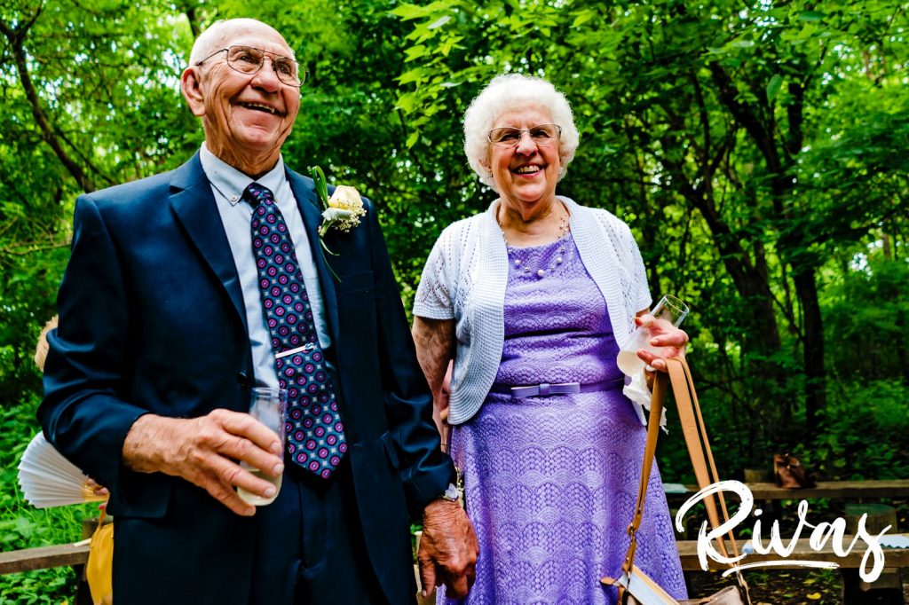 A bright, candid picture of a bride's mom and dad celebrating their daughter's marriage in Omaha. 