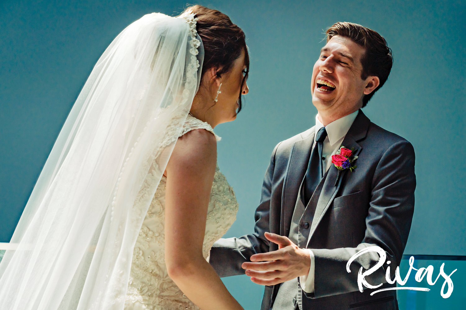 A candid picture of a bride and groom laughing together during their wedding day at the Museum at Prairiefire in Kansas City. 