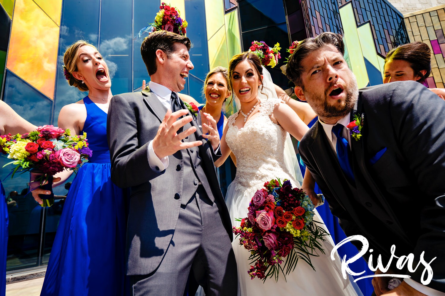A candid picture of a wedding party making silly faces and expressions towards the camera outside the Museum at Prairiefire on a wedding day. 