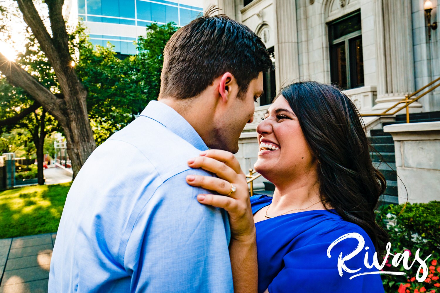 A candid picture of an engaged couple sharing an embrace and smiling at each other during their fall engagement session. 