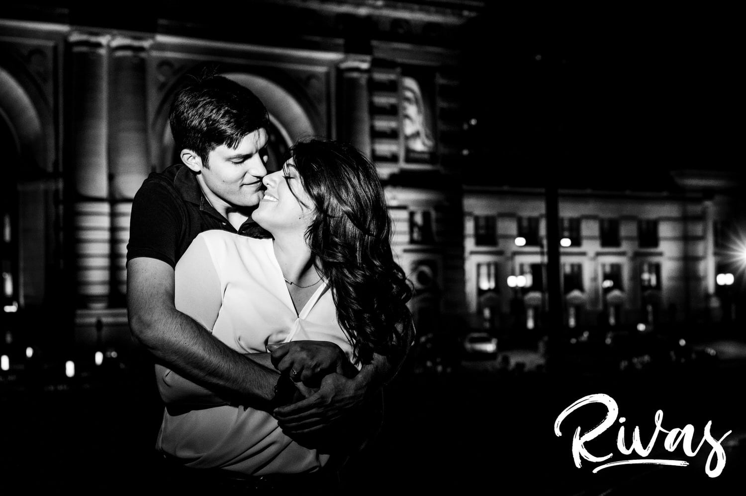 A candid black and white picture of an engaged couple sharing an intimate embrace during their fall engagement session in downtown Kansas City. 