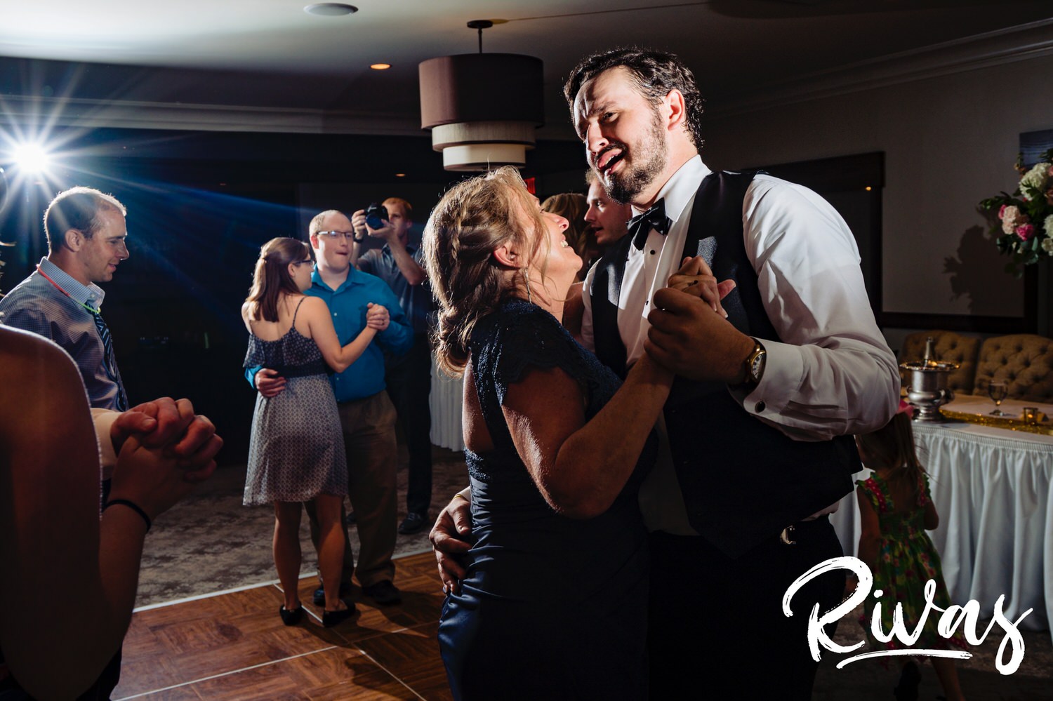 A candid picture of a groom's mom dancing with his brother during a wedding reception at Lawrence Country Club in August. 