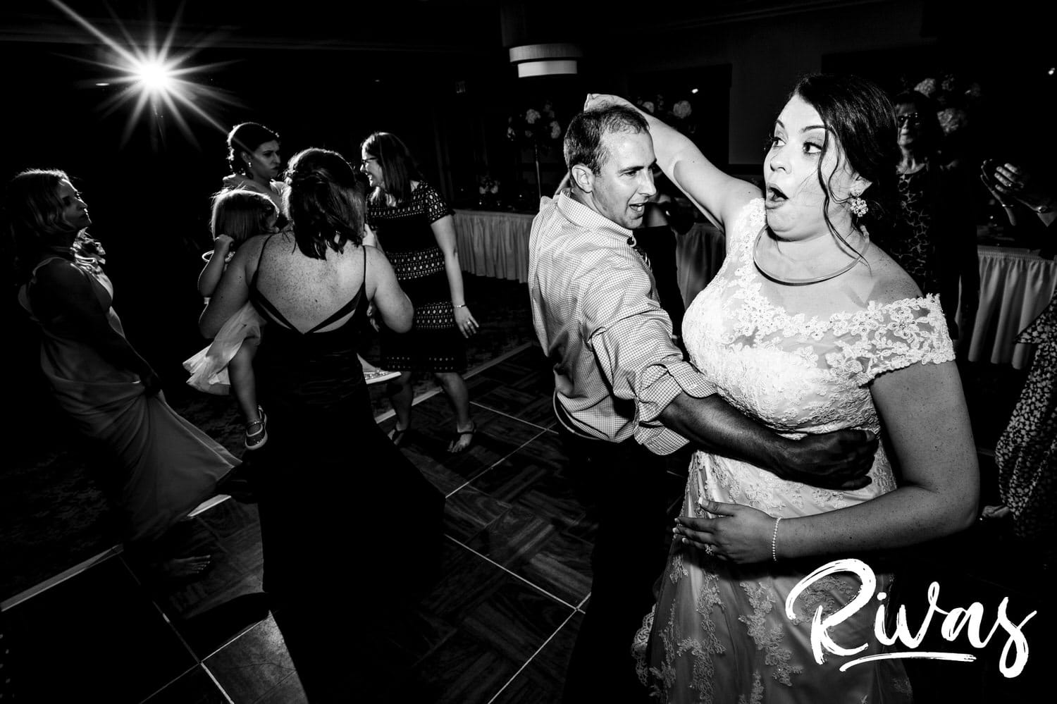 A candid picture of a bride dancing enthusiastically with her cousin during her summer wedding reception at Lawrence Country Club. 