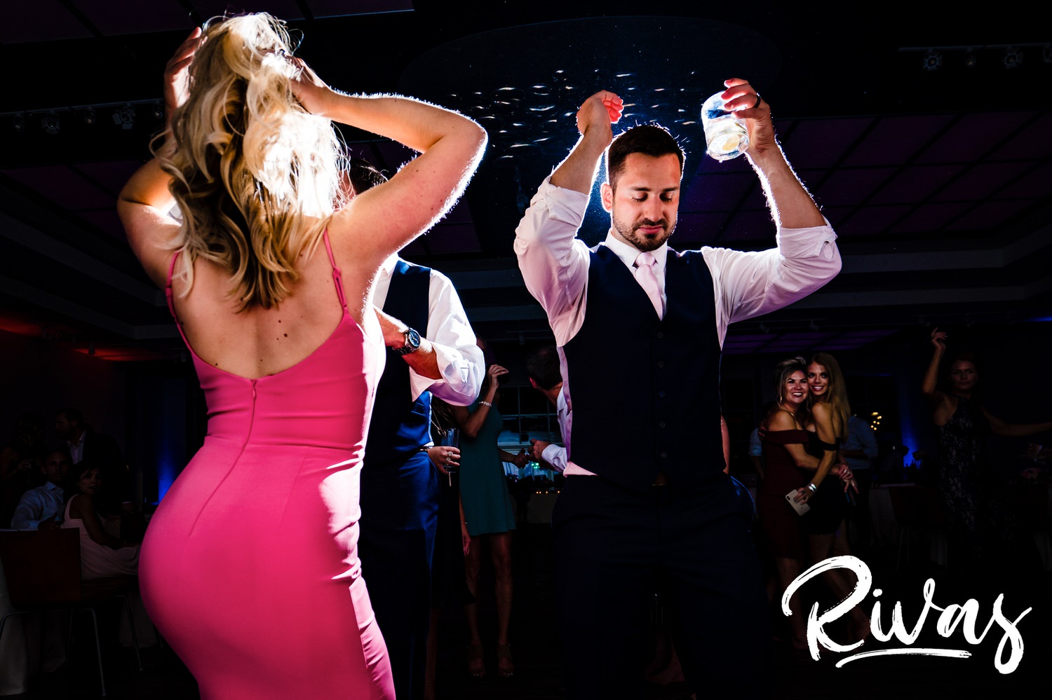 A candid picture of reception guests dancing together during a wedding reception at The Gallery Event Space in downtown Kansas City. 