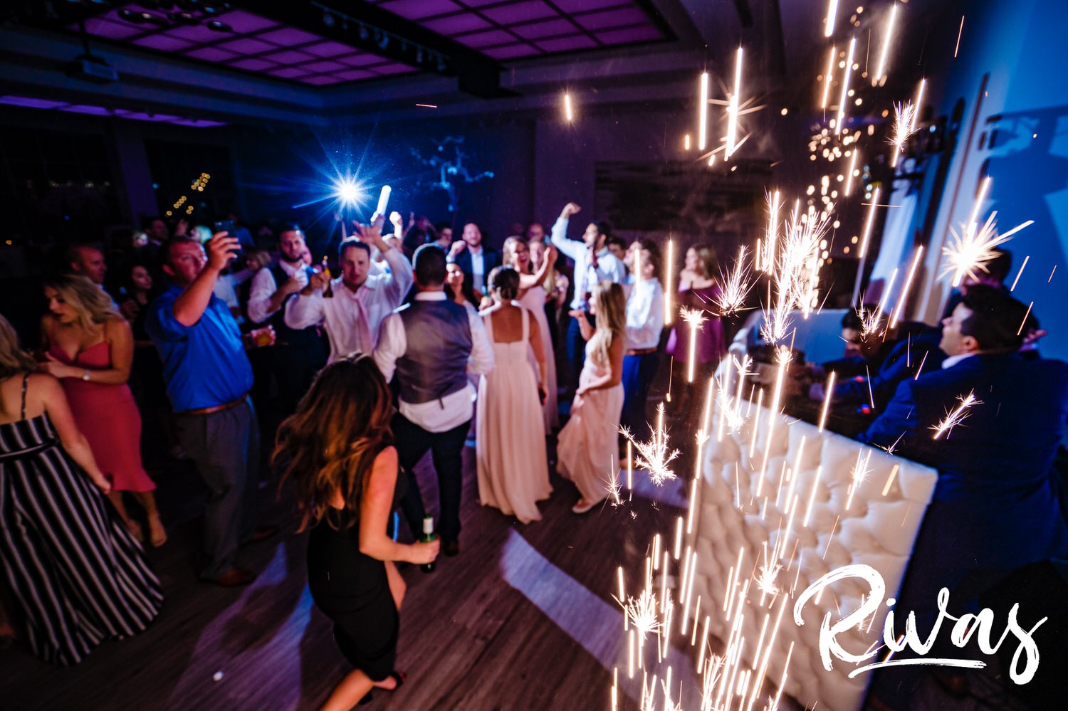 A candid picture taken from the ground up of a bride and groom dancing with friends during their wedding reception at The Gallery  Event Space in downtown Kansas City. 