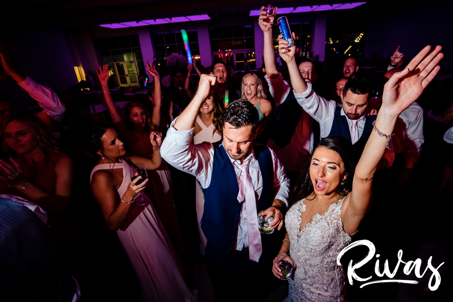 A candid picture taken from the ground up of a bride and groom dancing with friends during their wedding reception at The Gallery  Event Space in downtown Kansas City. 