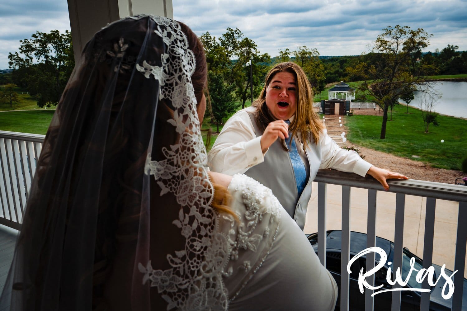 A candid picture of a bride reacting to seeing her bride for the first time on their wedding day at Fire Stables. 