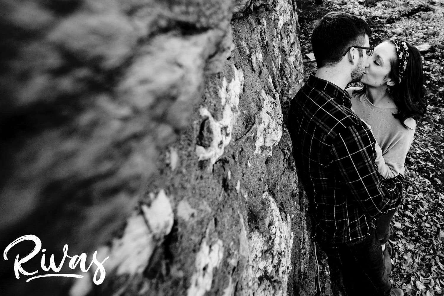 An intimate, black and white picture of an engaged copule sharing a kiss during their engagement session in Kansas City. 