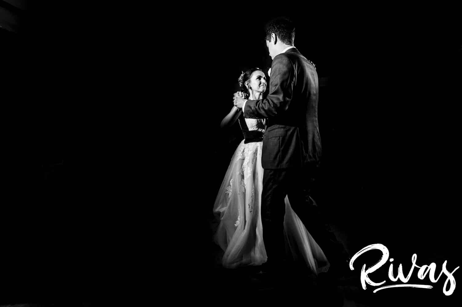 A dramatic black and white picture of a bride and groom sharing their first dance during their wedding reception at The Bowery. 