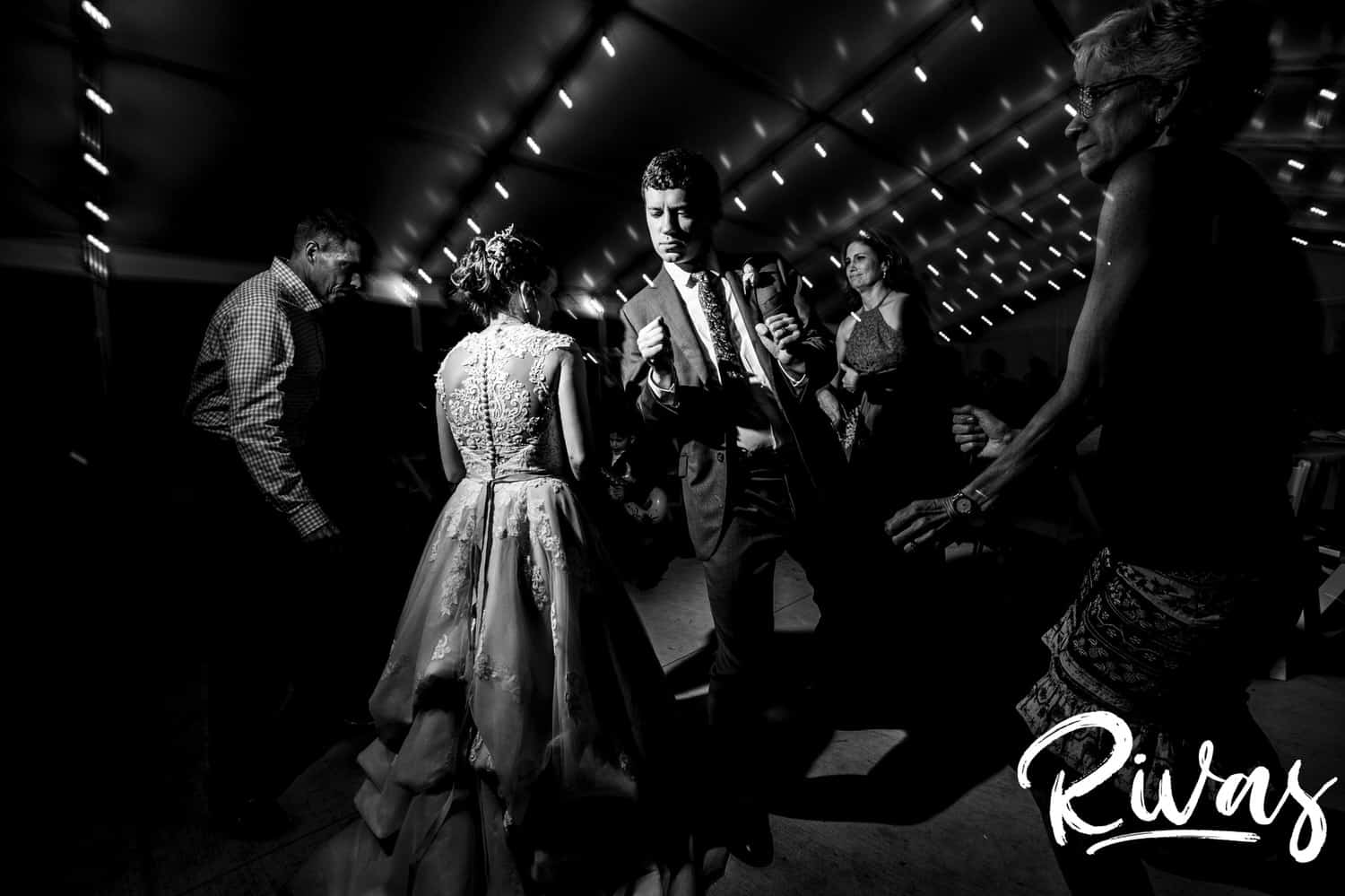 A candid black and white picture of a bride and groom dancing together during their wedding reception at The Bowery in Spring Hill. 