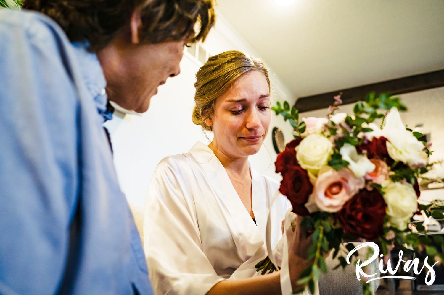 A colorful, emotional moment of a bride seeing her bouquet for the first time on the morning of her wedding at Piazza Messina in Cottleville, MO. 