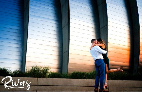 A genuine, carefree, candid engagement picture taken at sunset at the Kauffman Center for the Performing Arts during a summer engagement session in Kansas City.