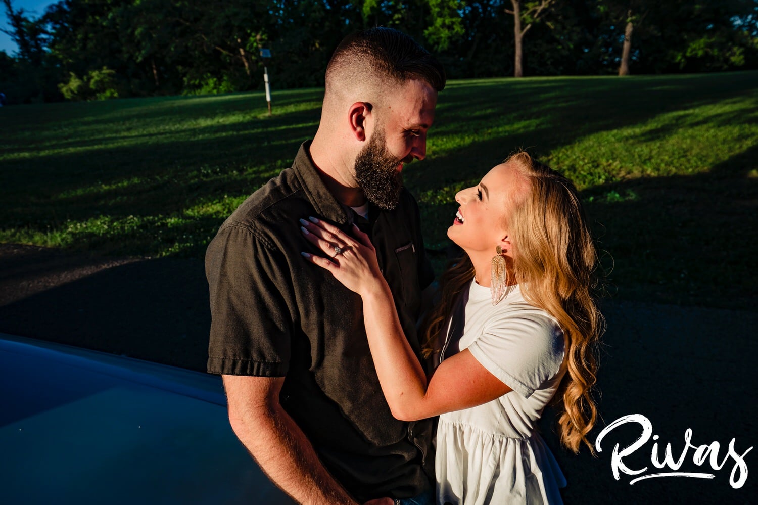 A cA colorful picture of a couple sharing an intimate embrace during their summer engagement session in Kansas City. 