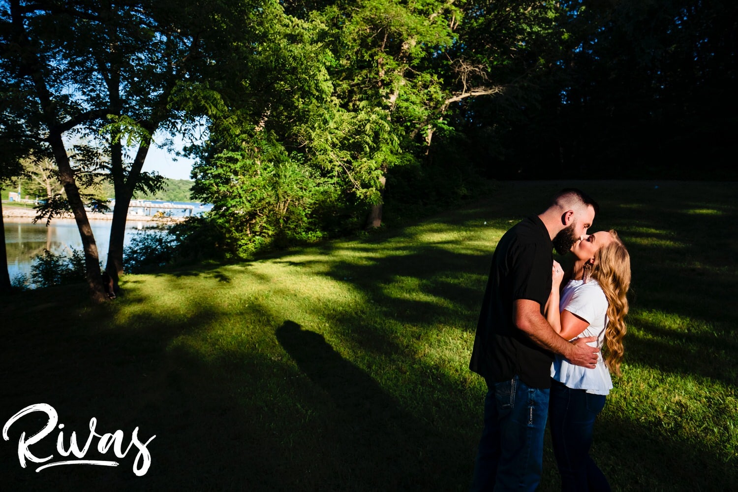 A vibrant portrait of an engaged couple sharing an embrace as they look at each other during an engagement session with their wedding photographer in Kansas City. 