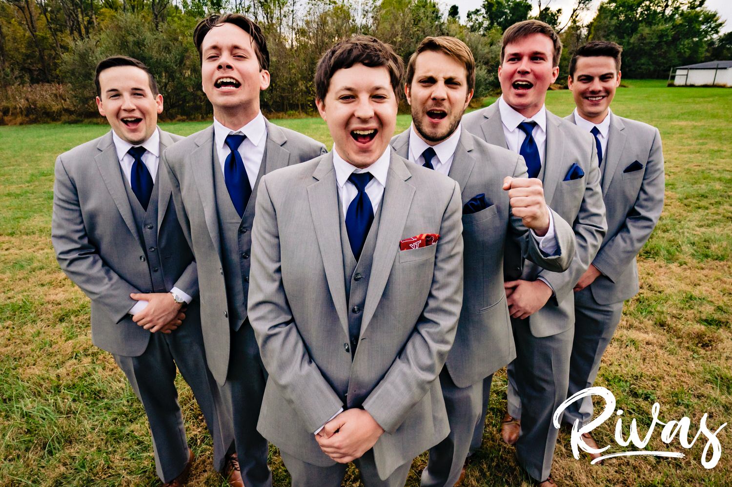 A colorful, candid picture of a groom and his groomsmen standing together laughing on the afternoon of his fall wedding at The Barns at Hamilton Station Vineyard. 