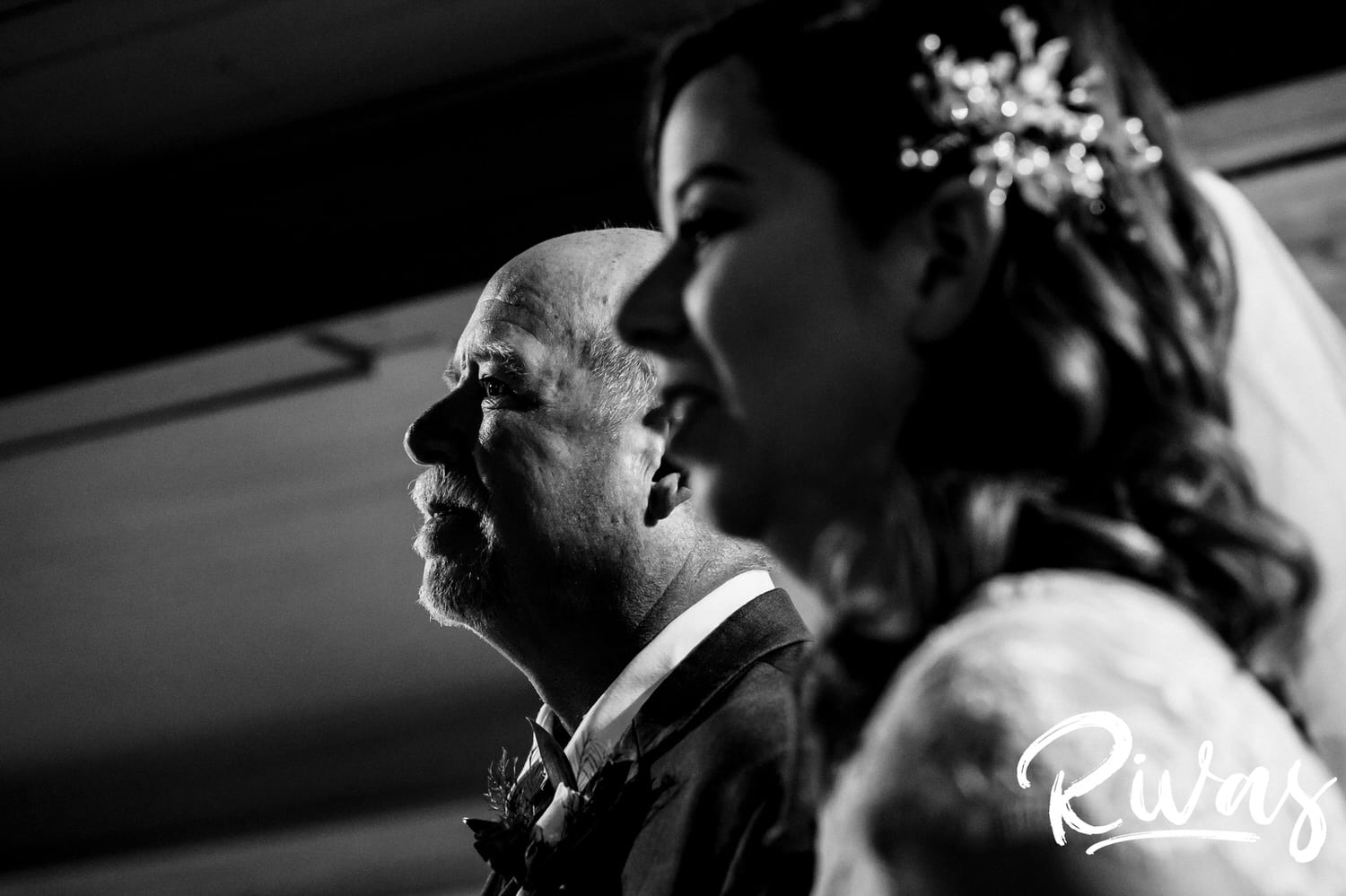 A close-up, candid black and white picture of a bride and her dad standing side by side waiting to walk down the aisle on her fall wedding day. 