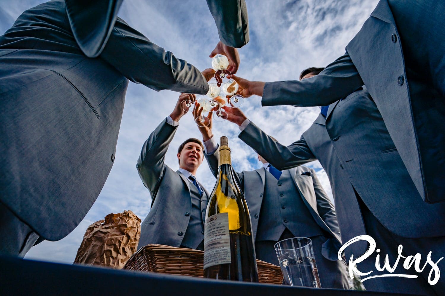A colorful, candid picture of a groom and his groomsmen toasting on the afternoon of his fall wedding at Hamilton Station Vineyard in Virginia. 