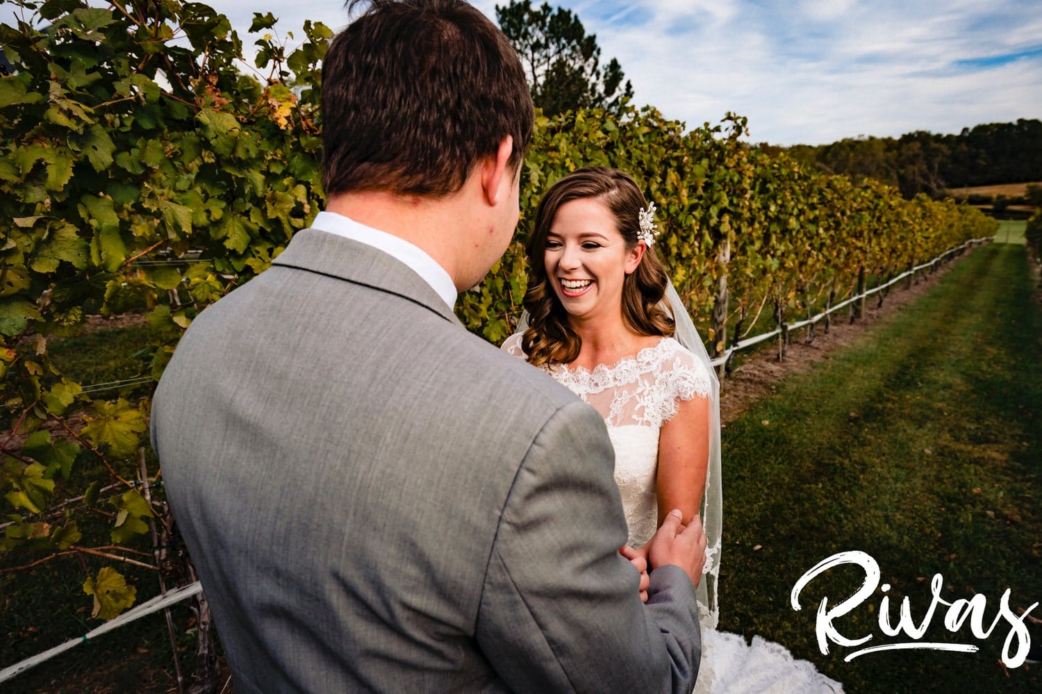 A colorful, candid picture of a bride embracing her groom during their first look on their fall wedding day at The Barns at Hamilton Station Vineyard. 