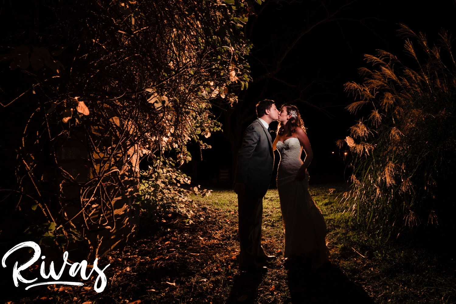 An intimate portrait of a bride and groom sharing a kiss at the end of their fall wedding reception at The Barns at Hamilton Station Vineyard. 