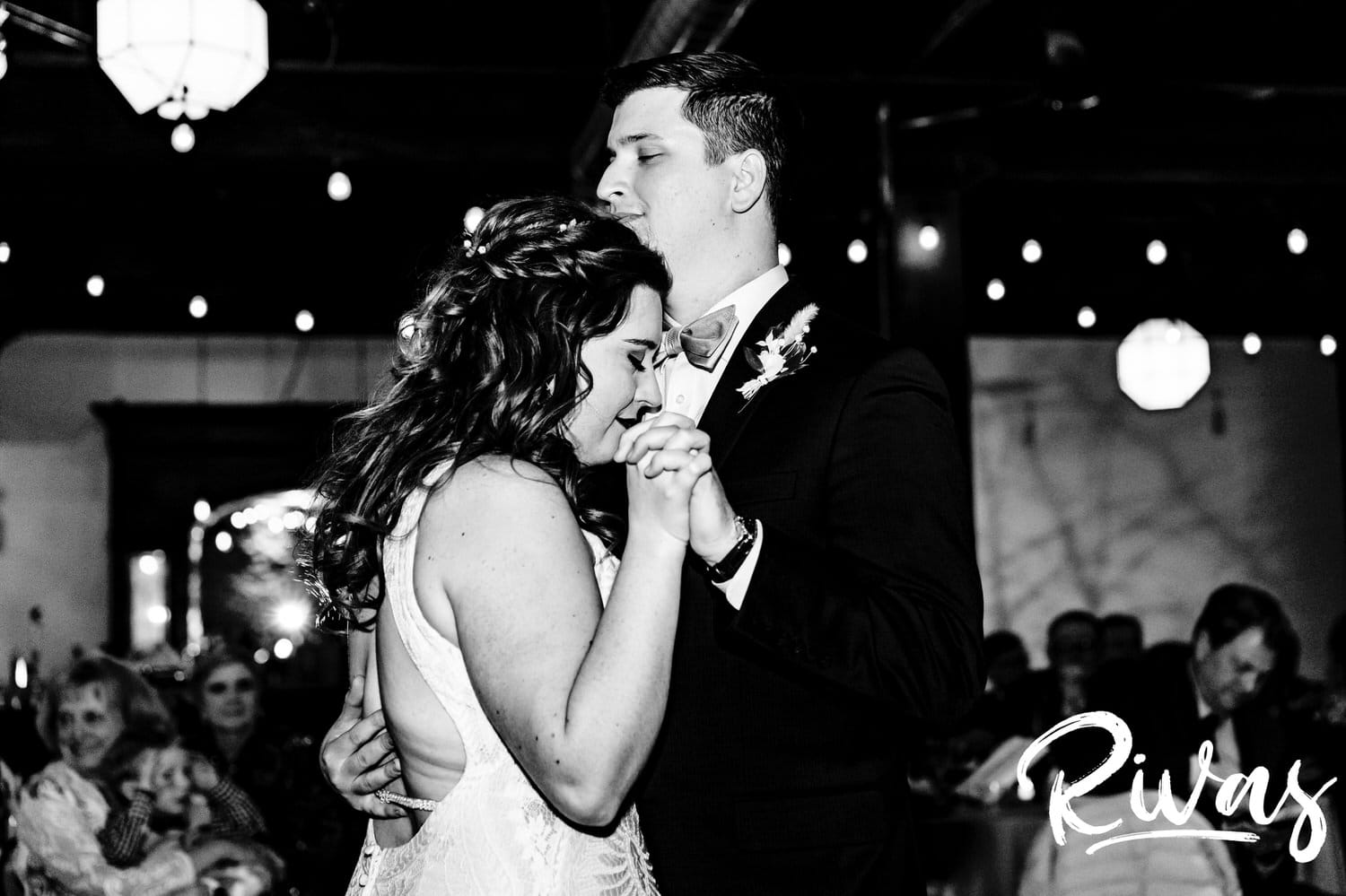 A candid black and white picture of a bride and groom sharing their first dance during their fall wedding reception at The Foundation Event Space in Kansas City. 