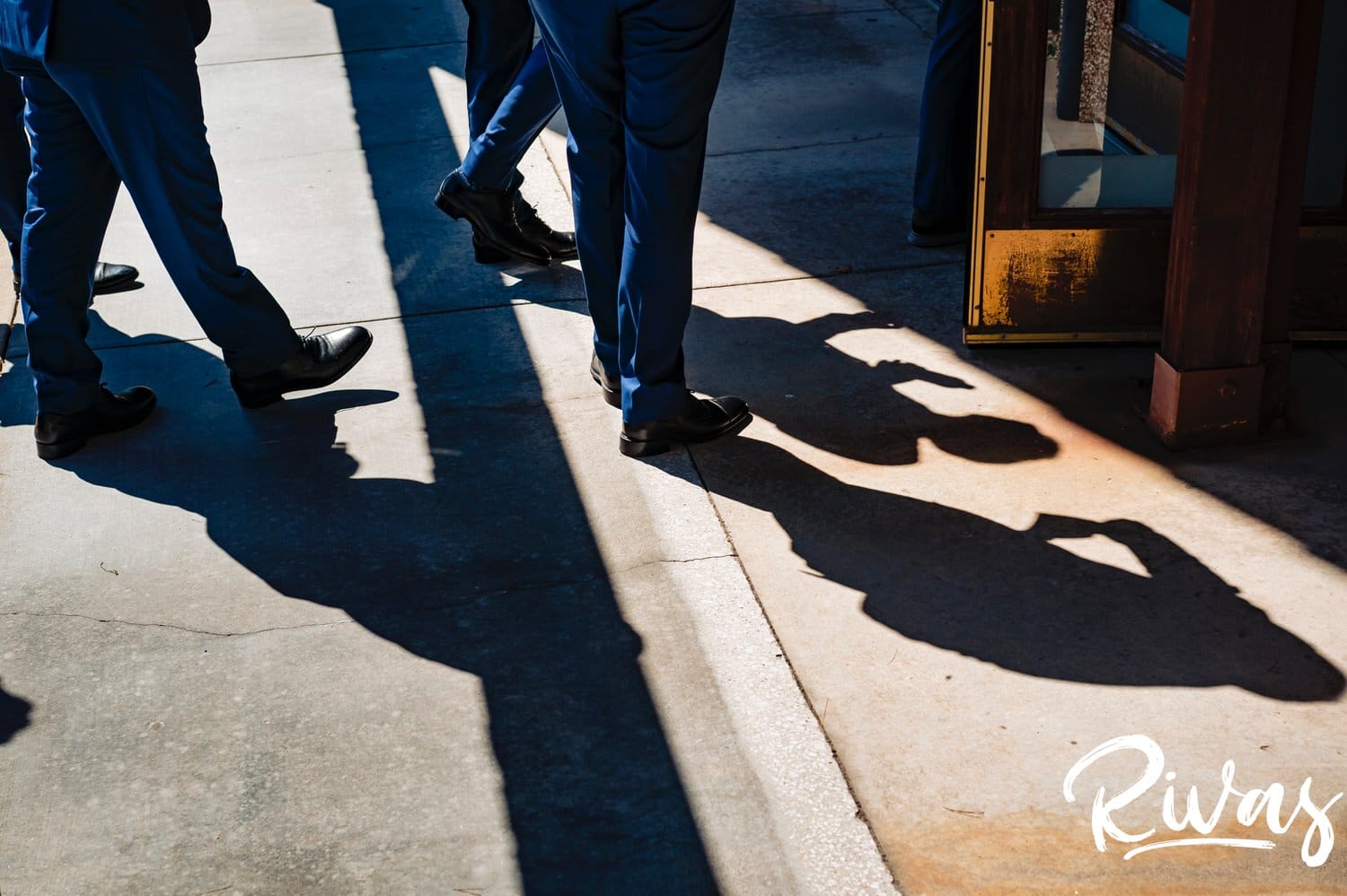An abstract picture of the shadows of a pair of groomsmen walking into a church on the afternoon of a wedding in Kansas City. 