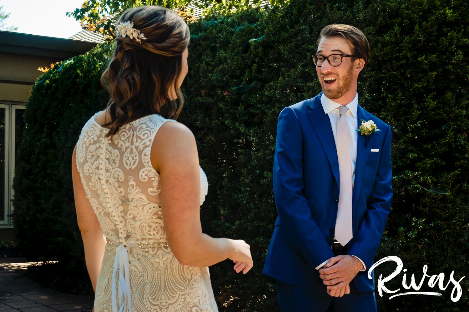 A candid, colorful picture of a groom turning around to see his bride for the first time on their sunny, summer wedding day in Kansas City. 