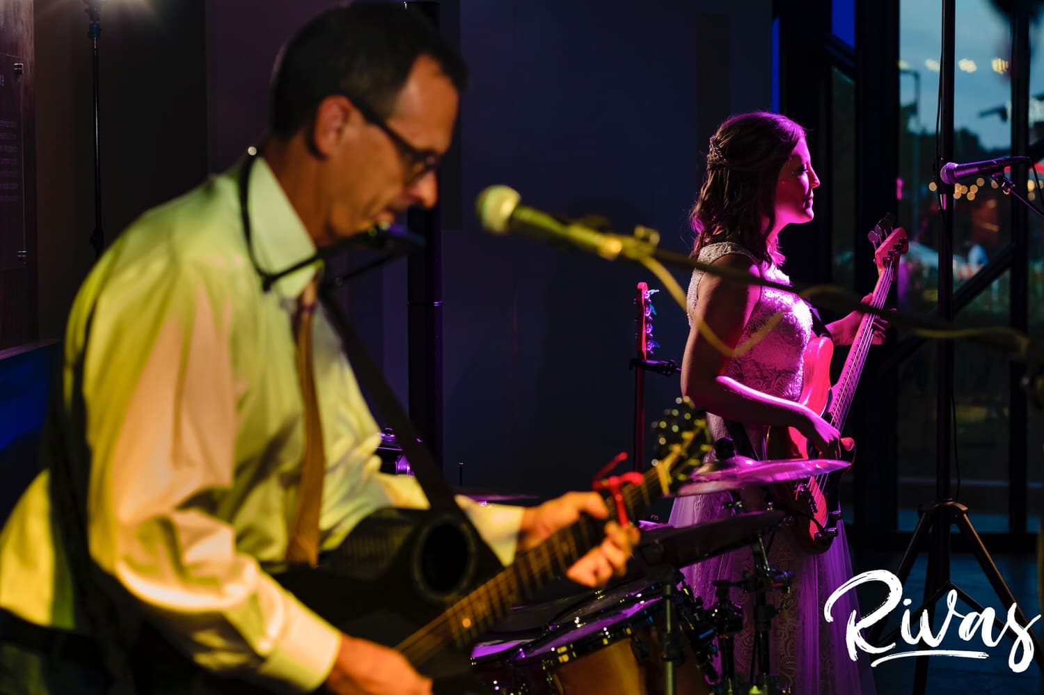 A colorful picture of a bride playing in a band with her dad during her Museum at Prairiefire wedding reception. 