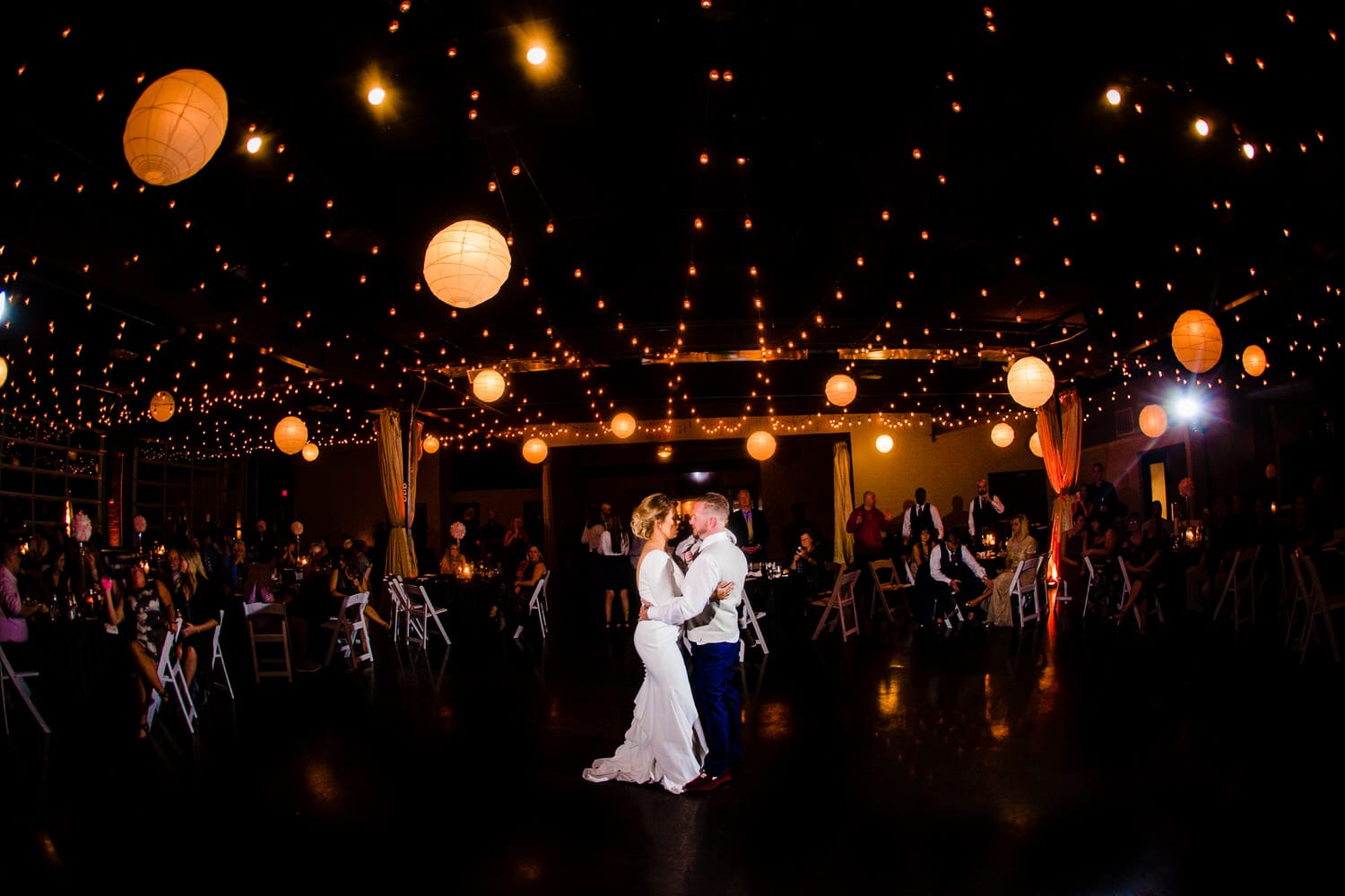 A wide picture of a bride and groom sharing their first dance at The Kansas City Room at 28 Event Space. 
