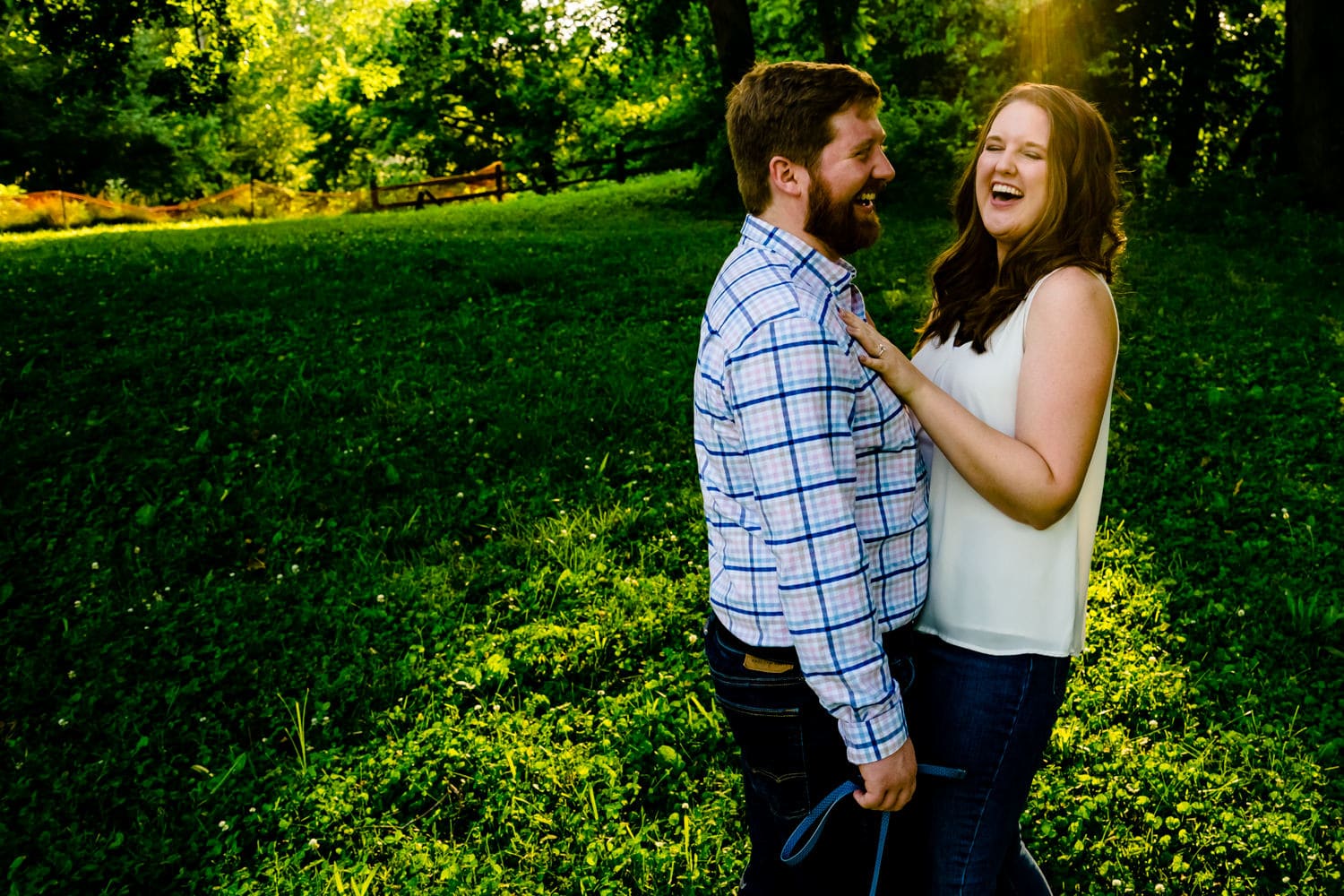 A candid,colorful picture of an engaged couple laughing together during their Kansas City engagement session. 