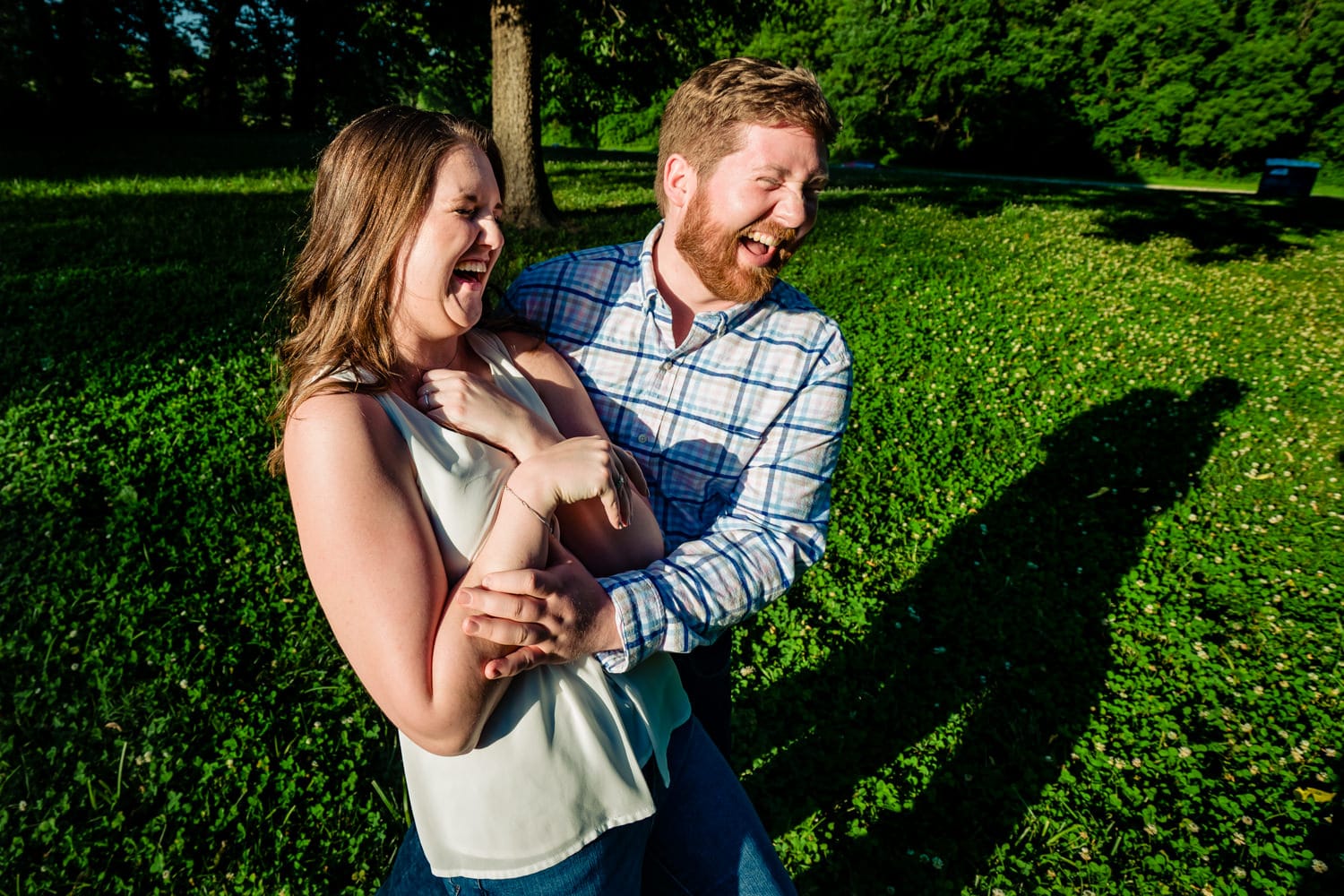 A candid, colorful picture of an engaged couple laughing together during their Kansas City engagement session. 