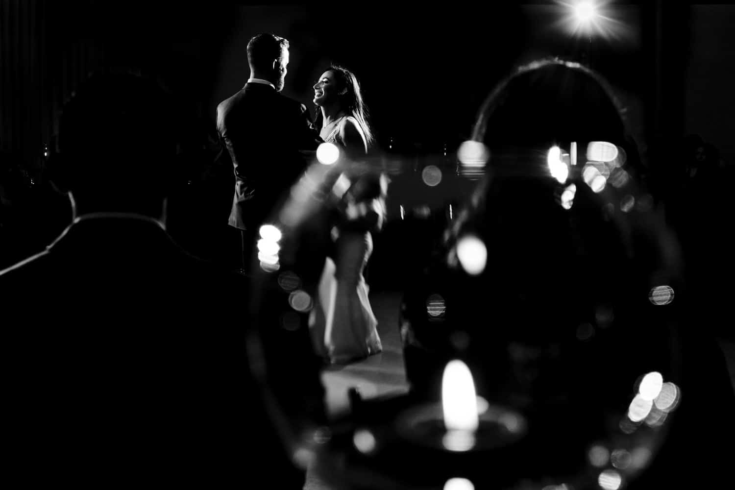 An up-close, intimate photo of a bride and groom sharing their first dance, their foreheads pressed together during their wedding reception at Pennway Place in Kansas City. 