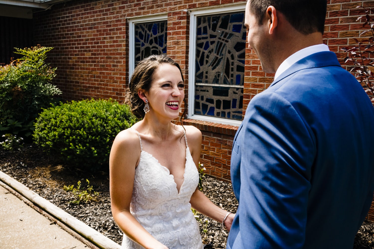 A colorful, candid picture of a bride seeing her groom for the first time on the afternoon of their intimate church wedding in Kansas City. 