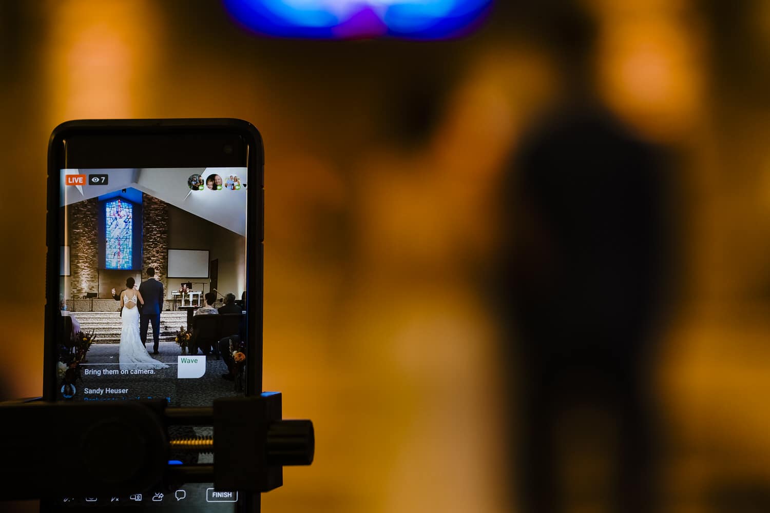 A picture of an iPhone on a tripod, live-streaming a wedding ceremony in Kansas City. 