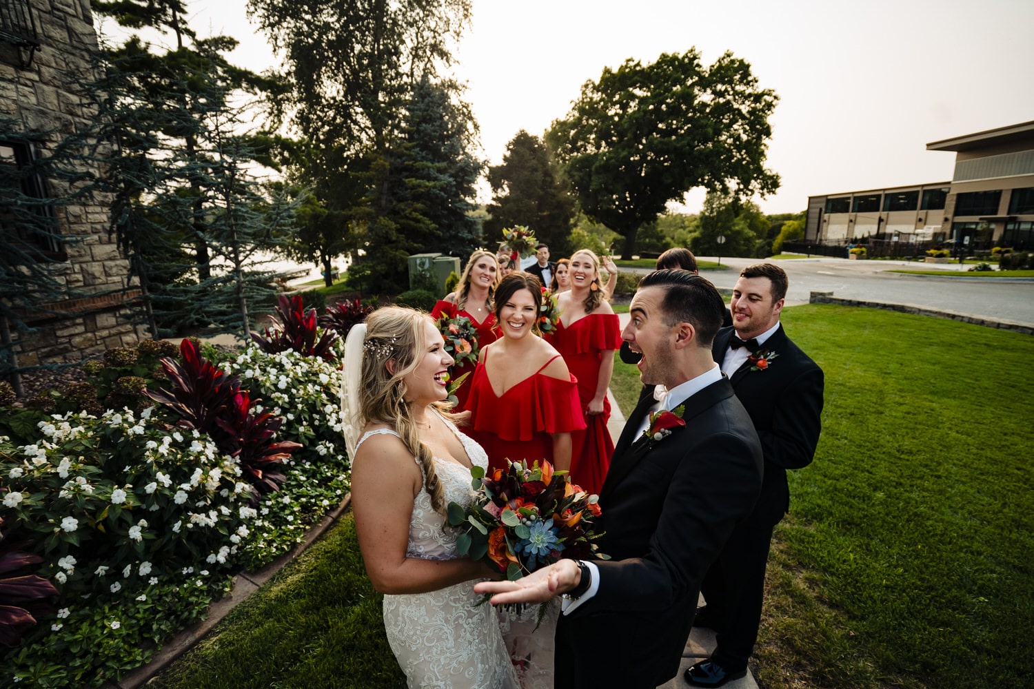 A candid, colorful picture of a bride and groom celebrating their marriage with their wedding party on a fall wedding day. 
