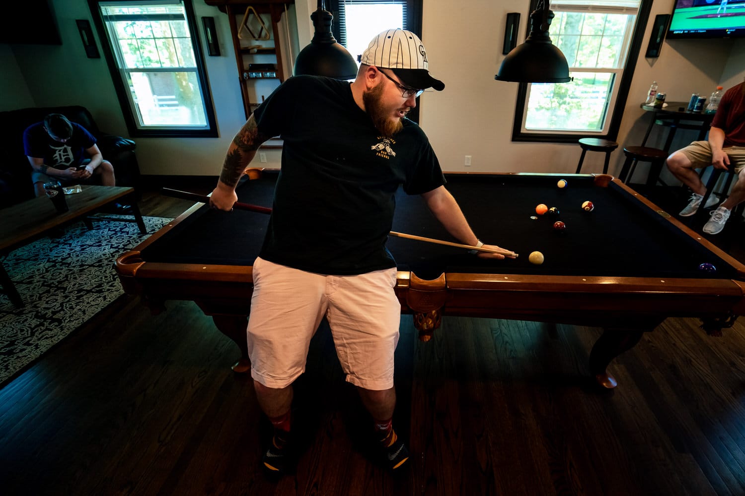 A colorful picture of a man shooting a pool cue behind his back. 