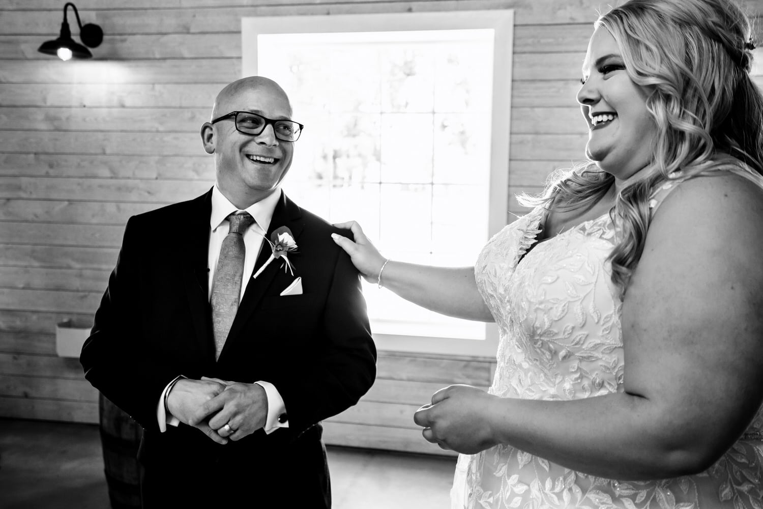 A candid black and white picture of a father-daughter first look on a summer wedding day at The Farmhouse KC Event Venue. 