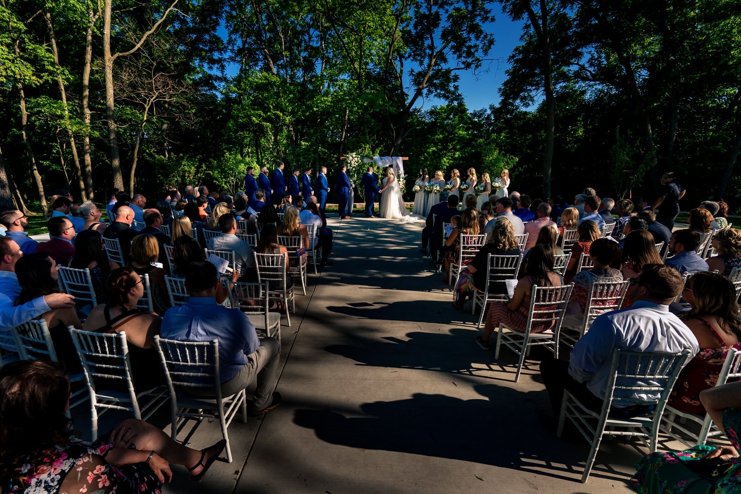 A wise, colorful picture of an outside wedding ceremony at The Farmhouse KC Event Venue. 