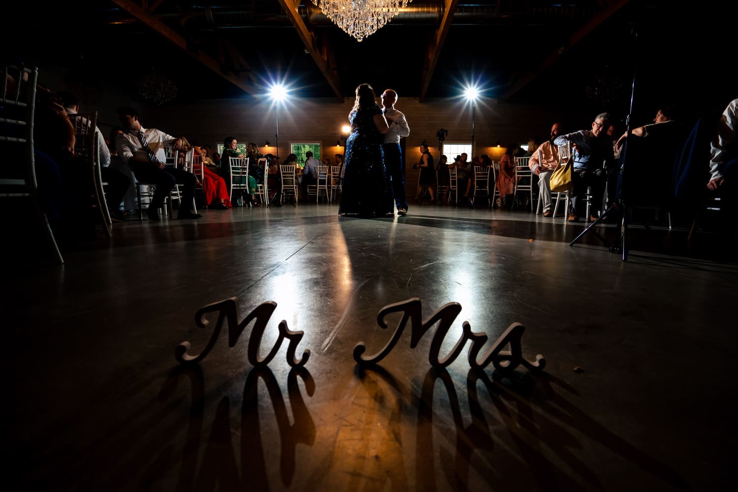 A wide picture of a bride's parents dancing together during a wedding reception in Kansas City. 