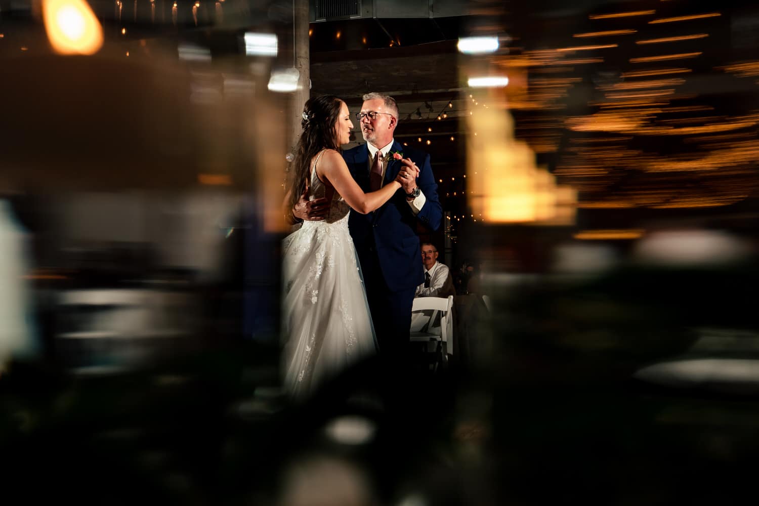 A colorful, candid picture of a father-daughter dance during a summer wedding reception at The Bride and The Bauer in Kansas City. 