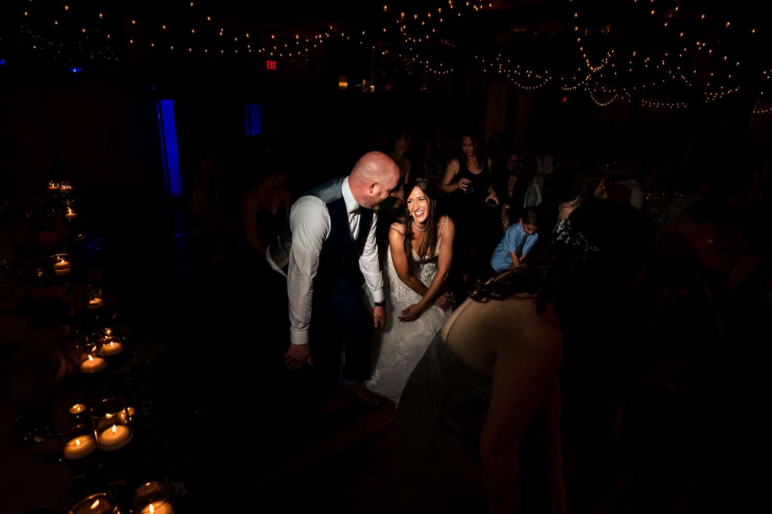 A colorful, candid picture of a bride and groom dancing during their wedding reception at The Bride and The Bauer in Kansas City. 